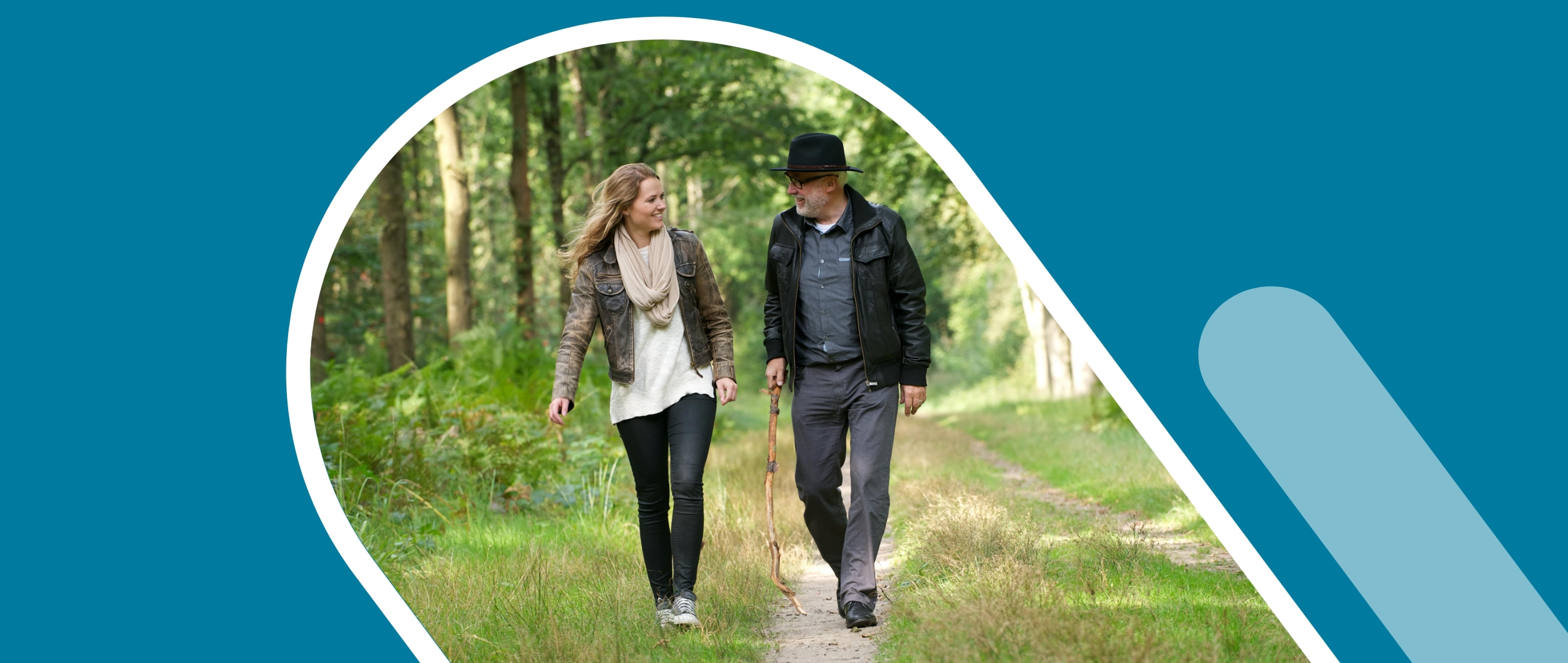 Young woman walking with older man in the forest